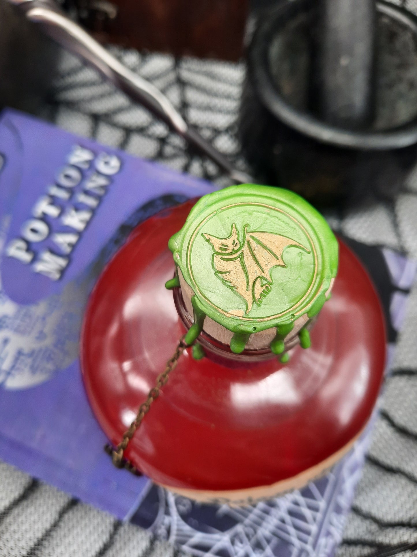 Gold bat wax seal on apple green wax