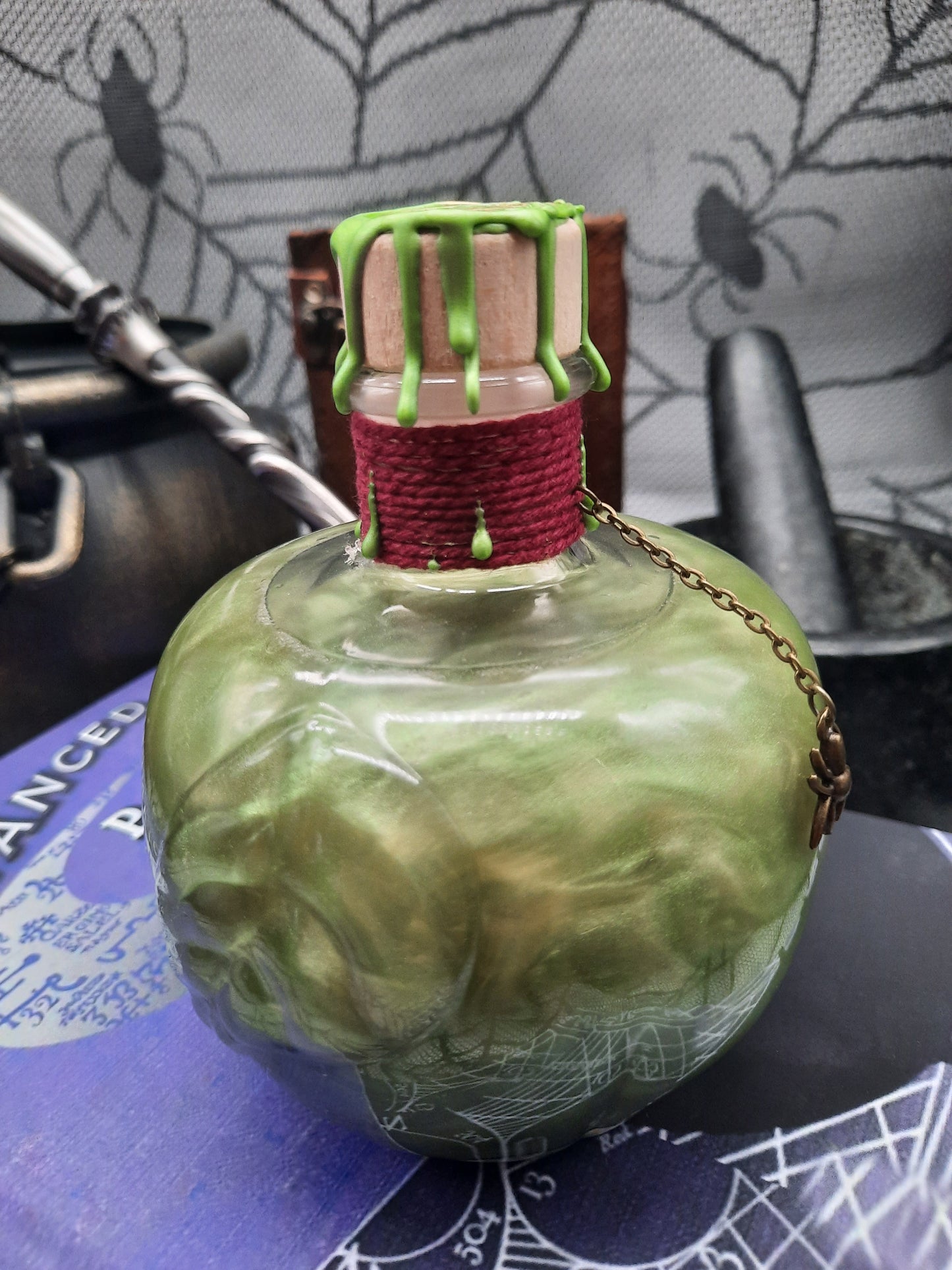 Poison potion shaken to green showing the leaf on the apple shaped bottle